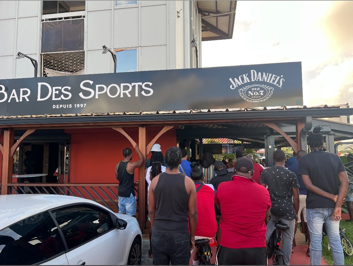 Façade extérieure du Bar des Sports avec bannière